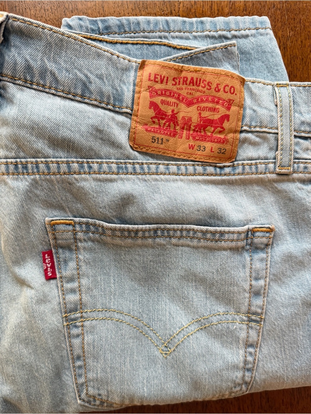 LEVI’s 511  light blue denim jeans with tan leather patch | Size 33x32